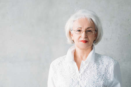 Senior lady portrait. Confident business female looking at camera. Classy smart successful corporate company ceo boss.の写真素材