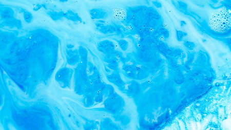Abstract blue paint background. Color gradient fluid flowing similar to river system covering rough uneven glitter surface.の写真素材