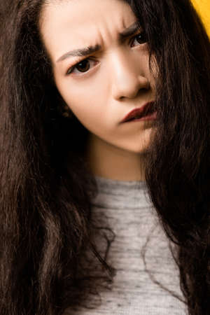 Closeup portrait of doubtful emotional brunette girl tilting head. Beautiful lady with disturbed,...