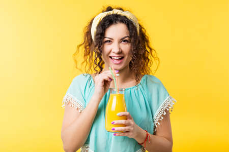 Excited young woman with straw bottle of fresh juice. Healthy nutrition lifestyle organic detox fruit smoothie cleansing drinkの写真素材