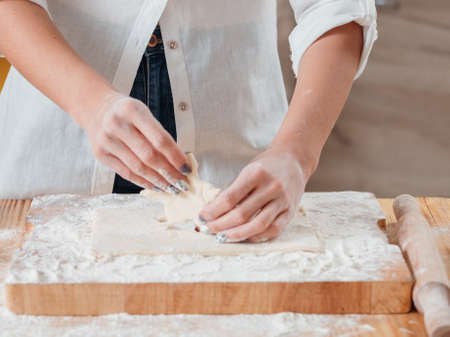 Bakery food and pastry. Biscuit cooking hobby. Closeup of female hands making cookies with homemade dough.の写真素材