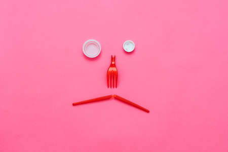 Disappointing ecological reality. Plastic garbage monster face on pink background. Zero waste lifestyle. Copy space.の写真素材