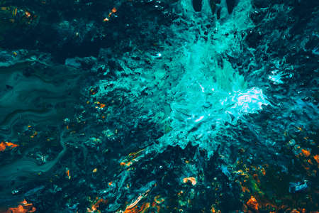 Abstract art texture background. Ocean surface design. Beautiful teal blue, white and orange paint mixture splash.の写真素材