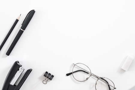 Business routine essentials. Office supplies set. Flat lay of stationery and eyeglasses over white background. Copy space.の写真素材