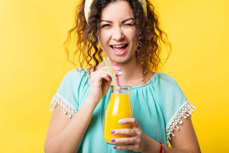 Healthy lifestyle. Balanced nutrition and wellness. Cute young lady holding bottle of fresh fruit...