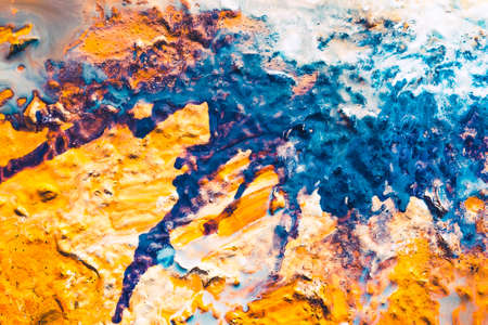 Abstract art texture background. Fantasy cake with glazed top and sugar powder. Orange and blue paint splash.の写真素材