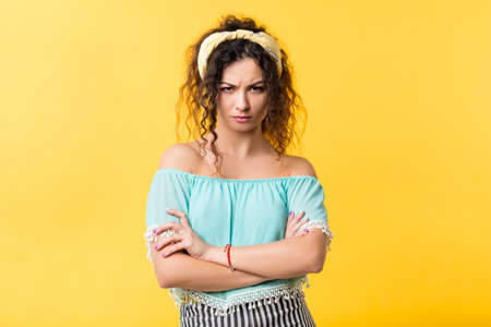 Portrait of overwhelmed emotional brunette girl with arms folded, grumpy facial expression, contemptuous look. Copy space.の写真素材
