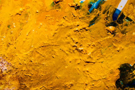 Abstract dark yellow paint background. Color effect similar to desert pattern texture. Fluid liquid...