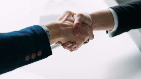 Successful partnership. Professional cooperation and agreement. Closeup of handshake. Business people making a deal.の写真素材