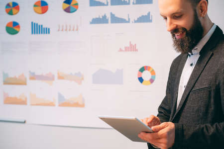 Successful career. Young business man running company. Male leader standing over defocused...