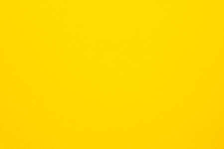 Bright yellow felt texture abstract art background. Colored construction paper surface. Copy space.の写真素材