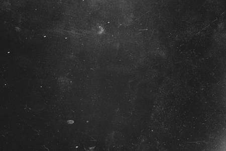 Dust and scratches design. Distressed photo editor layer. Black abstract background. Copy space.の写真素材