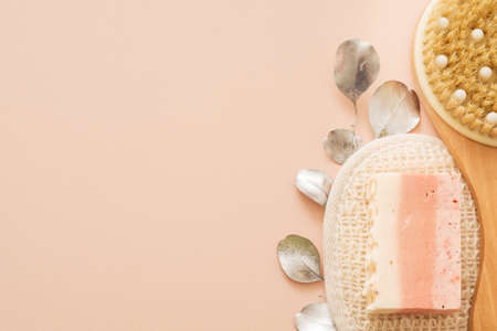 Body skin care and hygiene. Cropped top view of wooden body brush, organic loofah and handmade soap....