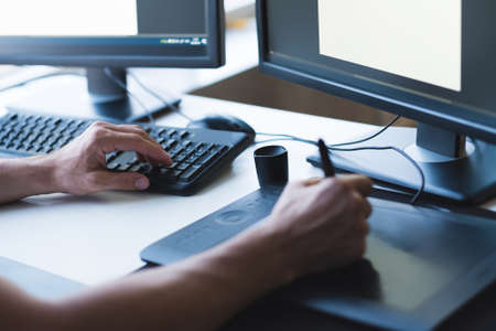 Web graphic design. Cropped shot of creative illustrator using tablet and pen for drawing.の写真素材