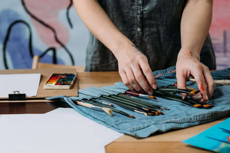 Professional artist tools. Cropped shot of painter choosing brush for working on new picture.の写真素材