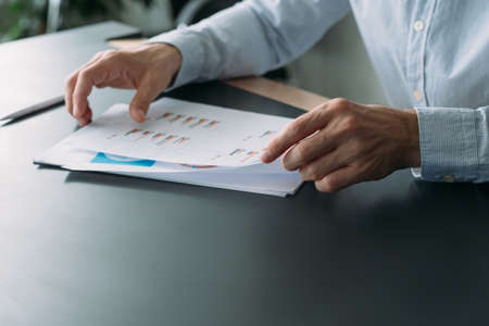 Business analysis. Cropped shot of man working with graphs and charts. Blur background. Copy space.