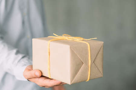 Online shopping. Cropped shot of business man received his order in paper wrapped box. Copy space.の写真素材