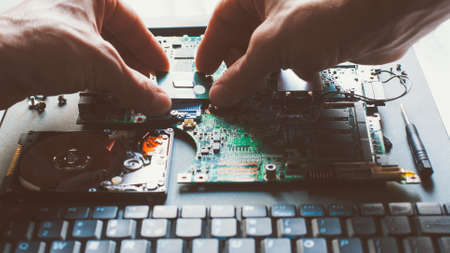 Electronic engineering. Processor installation. Technician plugging CPU microprocessor into...