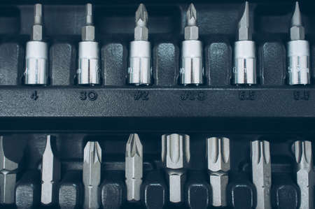 Toolbox socket organizer. Closeup of screwdriver bit set. Professional chrome instruments.