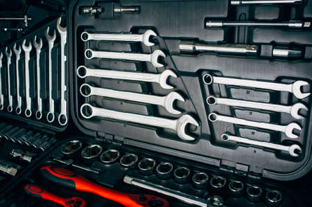 Mechanic essential instruments. Closeup of chrome wrench tools organized in box.