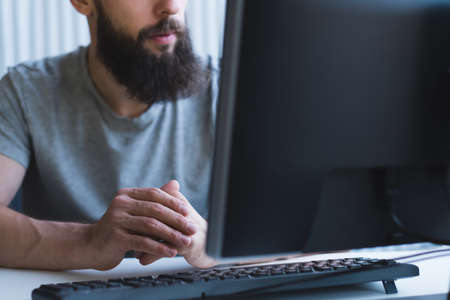 Software developer workplace. Cropped shot of male programmer working on code.