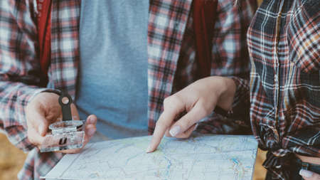 Wanderlust and adventures. Cropped shot of travelers using compass and map to explore country.