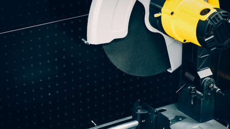 Engineering equipment. Closeup of industrial circular saw over black metal background.の写真素材