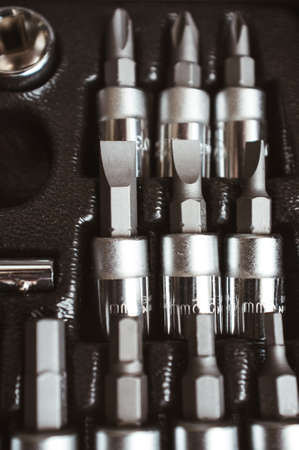 Toolbox socket organizer. Closeup of screwdriver bit set. Professional chrome instruments.
