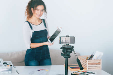 Modern technology in art. Female influencer recording tutorial video about new drawing application. Copy space.の写真素材