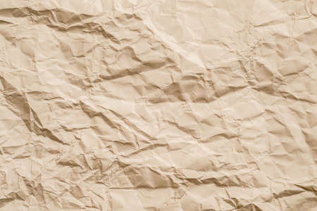 Blank beige crumpled paper. Aged effect. Biodegradable material. Abstract art background. Copy space.の写真素材