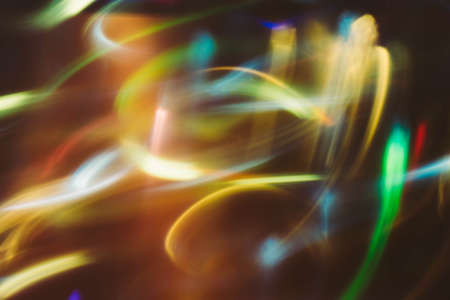 Neon multicolor glowing lines. Defocused gleam in motion. Dark abstract art background.の写真素材