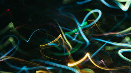 Blur neon yellow. Blue glowing curvy lines. Colored light leak effect. Dark abstract art background.
