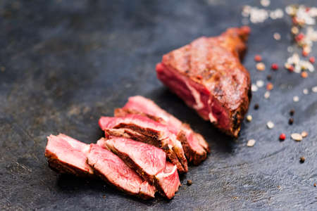 BBQ meat recipe. Cowboy steak. Sliced medium grilled beef and mixture of peppers.の写真素材
