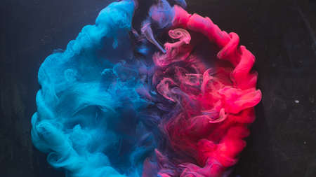 Ink water explosion. Harmony balance. Blue pink acrylic paint spill. Abstract art background.の写真素材