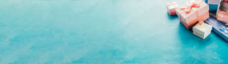 Special day surprise. Cropped closeup of jewelry gift boxes assortment on aqua blue textured background. Copy space.の写真素材