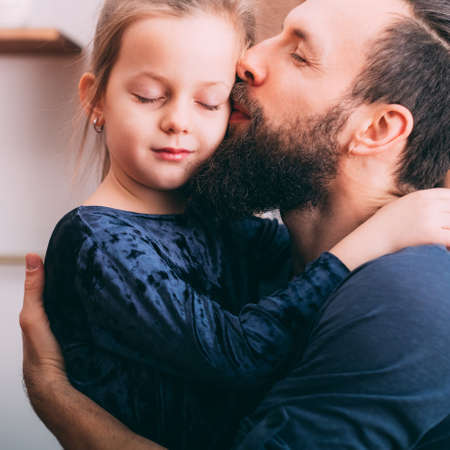Happy parenting. Portrait of father showing love and care to his cute little daughter.の写真素材