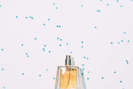 Luxury gift. Cosmetic shop sale. Cropped flat lay of perfume bottle on blue star pattern white...