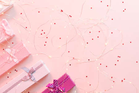 Festive occasion present. Cropped flat lay of jewelry gift boxes on star pattern pink background. Copy space.の写真素材