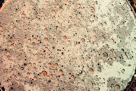 Abstract art background. Beige enamel with bubbled texture surface. Hollow out design.