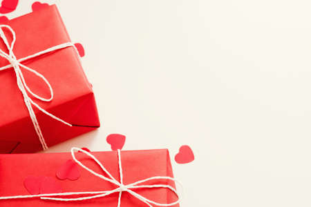 Saint Valentine day. Cropped flat lay arrangement of red gift boxes and heart cutout ornament on...