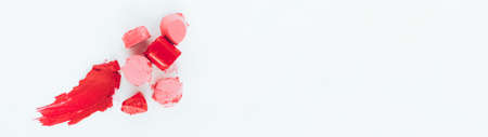 Decorative cosmetics, makeup. Smeared pink, red lipstick samples on white background.の写真素材