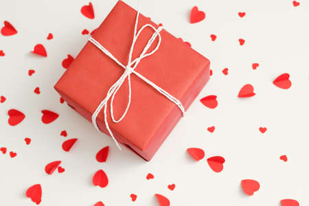 Saint Valentine day. Top view of red gift box on heart pattern white background.の写真素材
