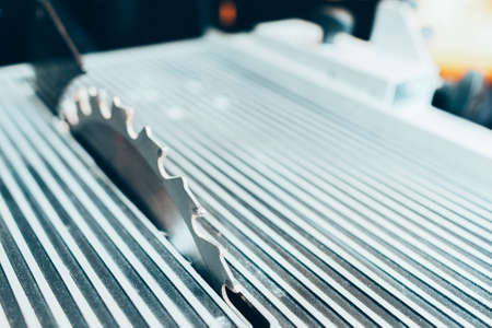 Woodwork industrial equipment. Closeup of chrome electric saw in workshop. Copy space.の写真素材