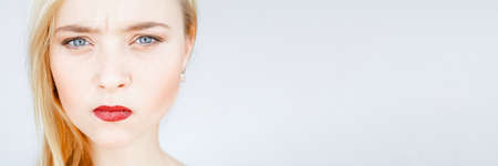 Anger, offence. Annoyed, mad, disappointed woman Smooth face skin red lipsの写真素材