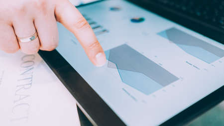 Business strategy planning and analysis. Closeup of man hand pointing finger at statistics on laptop screen.の写真素材