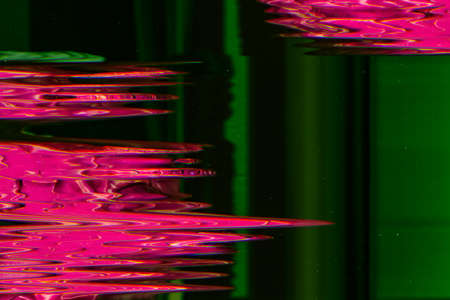 Colorful noise background. Digital glitch. Pink defect on green dust surface.の写真素材