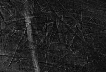 Black aged background. Distressed textile texture. Abstract crumpled scratched surface.