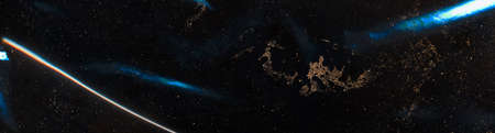 Galaxy abstract background. Cosmic dust. Bronze glitter stars blue light rays on black.