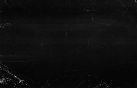 Dirty broken glass. Grunge overlay. Black weathered TV screen with white dust scratches.の写真素材
