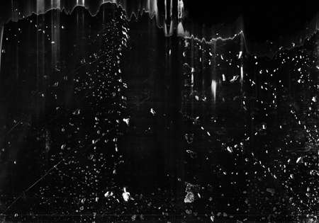 Grunge background. Stained texture. Black scratched surface with water drops.